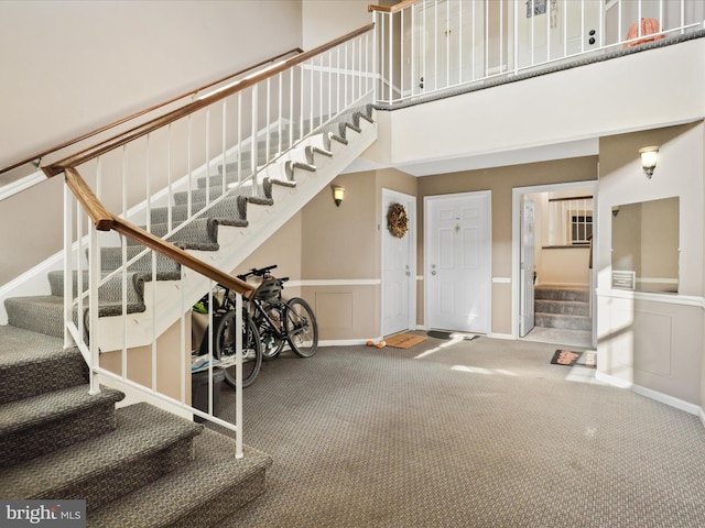 foyer entrance with carpet