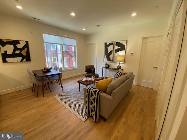 living room with light hardwood / wood-style flooring