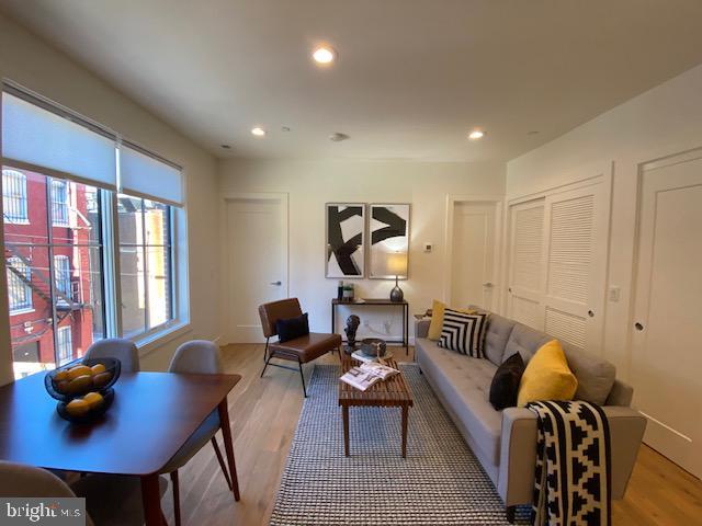 living room with light hardwood / wood-style flooring