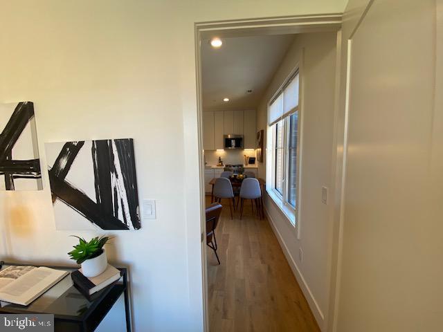 corridor with wood-type flooring