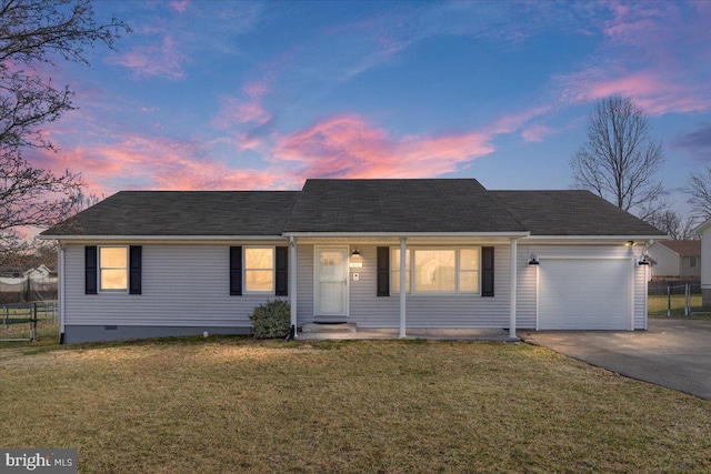 ranch-style house featuring a lawn and a garage