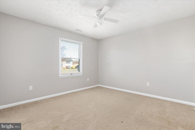 unfurnished room with carpet flooring, a textured ceiling, and ceiling fan