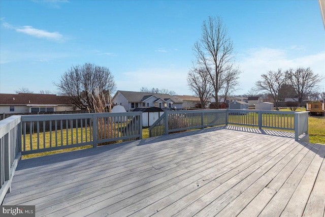 deck with a lawn and a shed