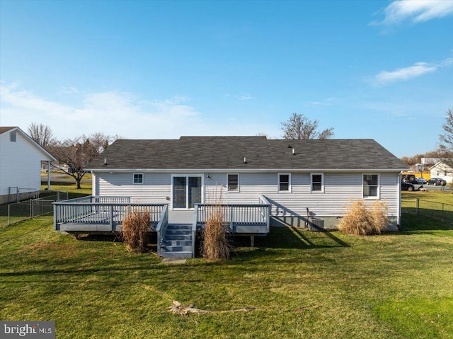 rear view of house featuring a lawn and a wooden deck