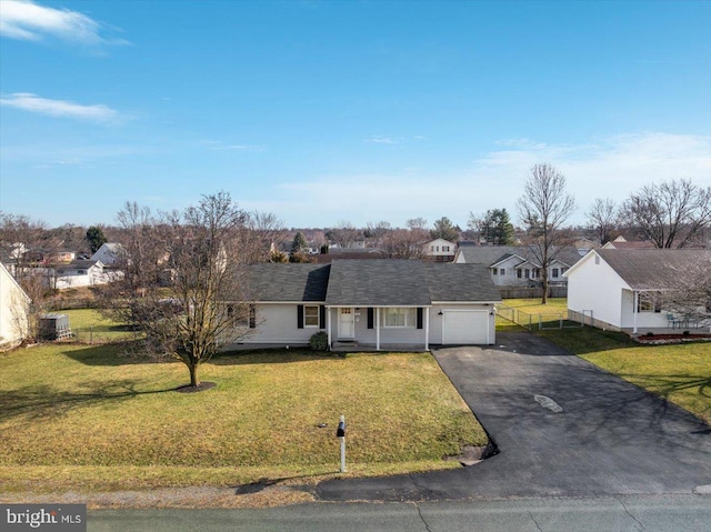 view of front of home with a front yard and a garage