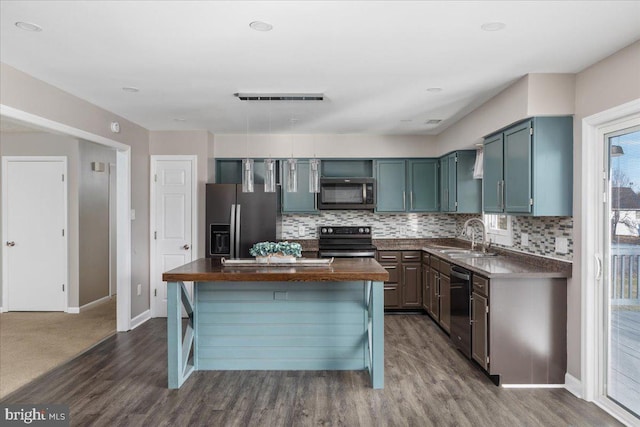 kitchen featuring sink, dark hardwood / wood-style floors, tasteful backsplash, butcher block counters, and stainless steel appliances