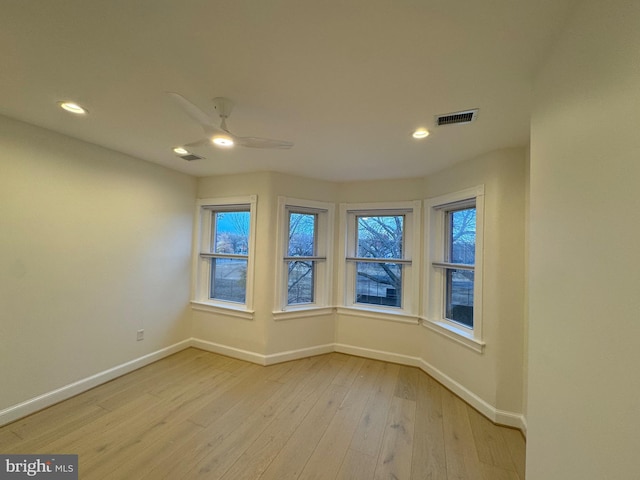 unfurnished room with ceiling fan and light hardwood / wood-style floors