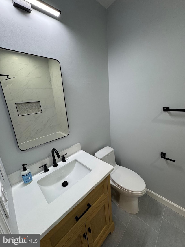 bathroom featuring tile patterned flooring, vanity, and toilet