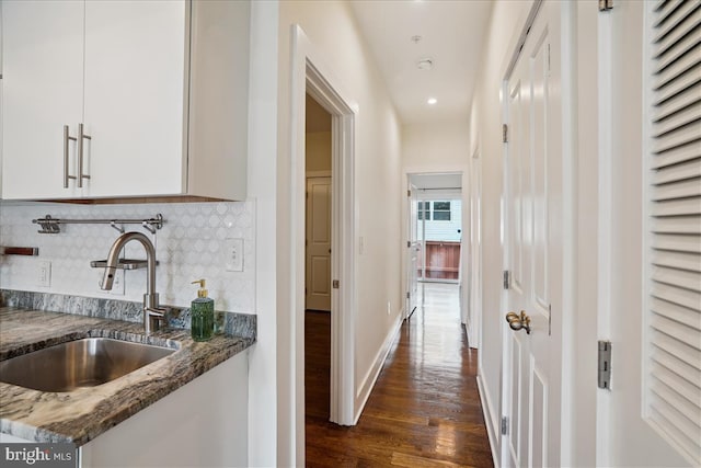 corridor with sink and dark hardwood / wood-style floors