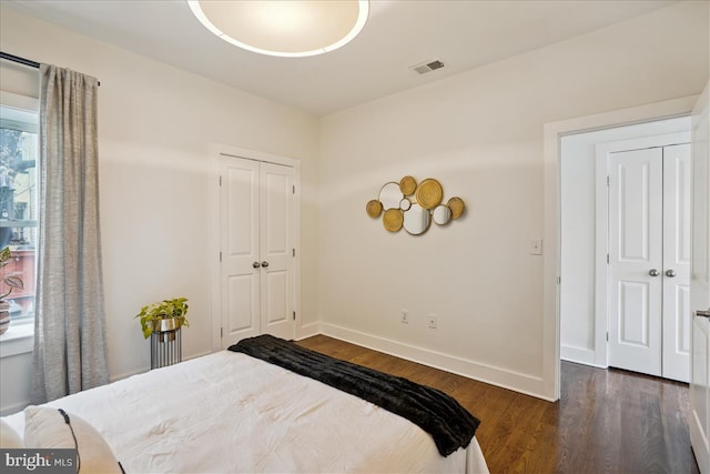 bedroom with dark hardwood / wood-style flooring