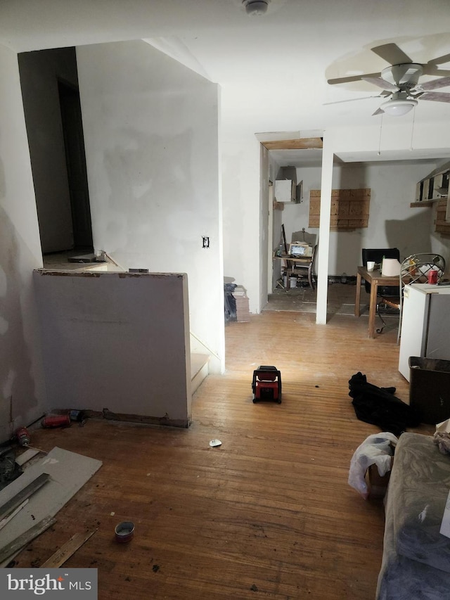 living room with hardwood / wood-style floors and ceiling fan