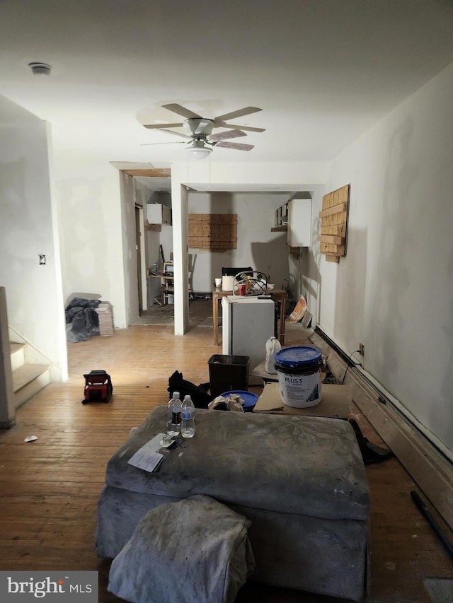 living room with hardwood / wood-style flooring and ceiling fan