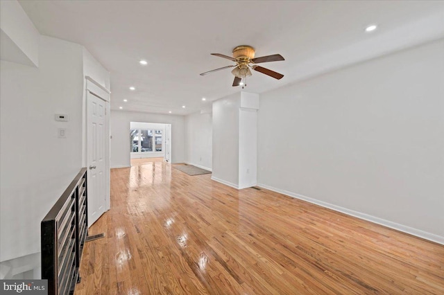 unfurnished living room featuring light wood-type flooring and ceiling fan