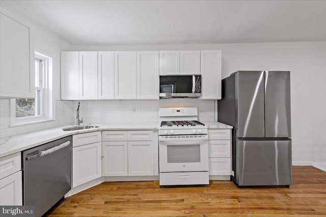 kitchen featuring sink, white cabinets, and stainless steel appliances