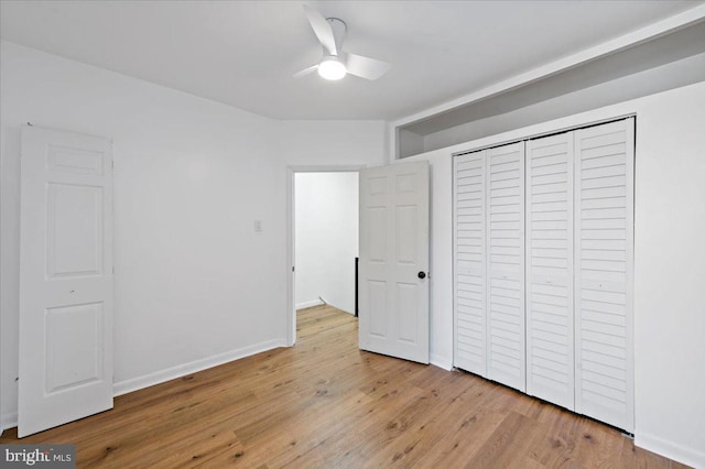 unfurnished bedroom featuring ceiling fan, a closet, and light hardwood / wood-style floors