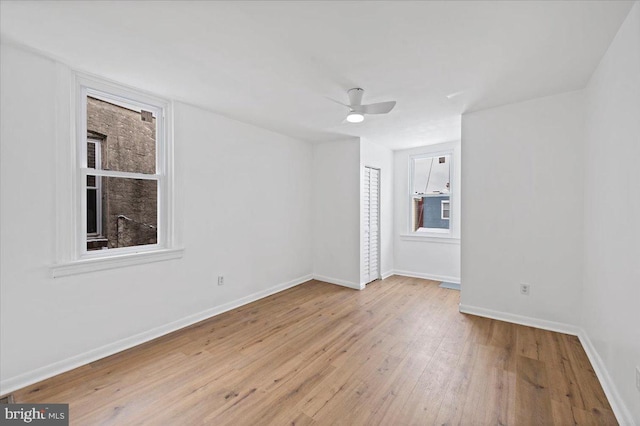 unfurnished room with ceiling fan and light wood-type flooring