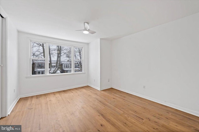 empty room with ceiling fan and light wood-type flooring