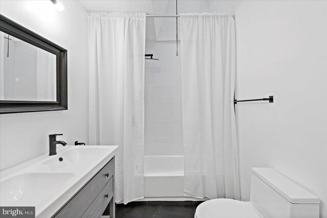 full bathroom featuring vanity, shower / bathtub combination with curtain, and toilet