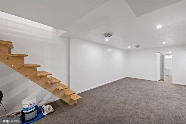 basement featuring dark colored carpet