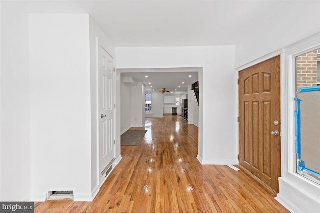 entryway with ceiling fan and light wood-type flooring