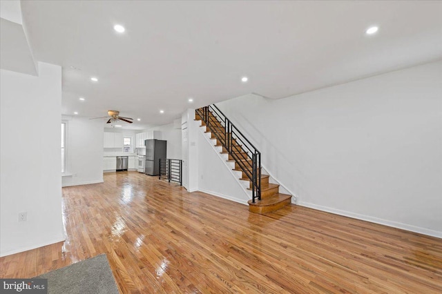 unfurnished living room featuring light hardwood / wood-style floors and ceiling fan