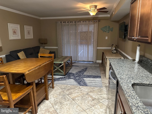 tiled dining space with ceiling fan, ornamental molding, and sink