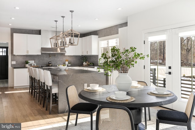 dining space with plenty of natural light and light wood-type flooring