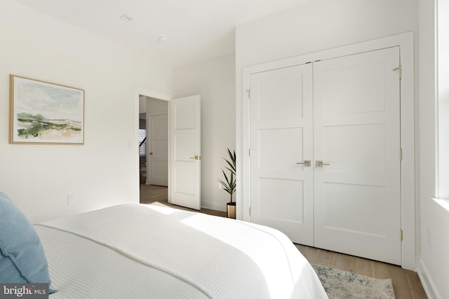 bedroom featuring light wood-type flooring and a closet