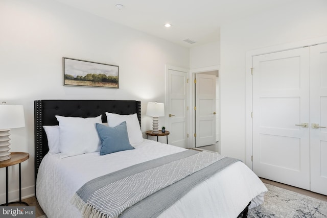 bedroom with a closet and hardwood / wood-style floors