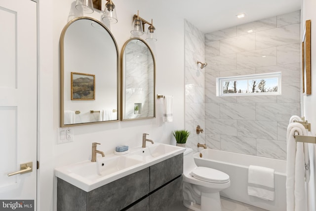 full bathroom featuring toilet, vanity, and tiled shower / bath