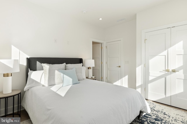 bedroom featuring hardwood / wood-style floors and a closet