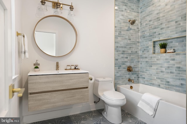 full bathroom with vanity, tiled shower / bath combo, and toilet