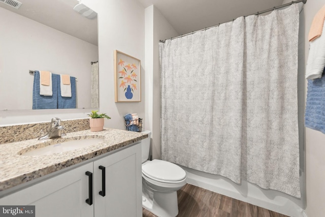 bathroom with hardwood / wood-style flooring, vanity, and toilet