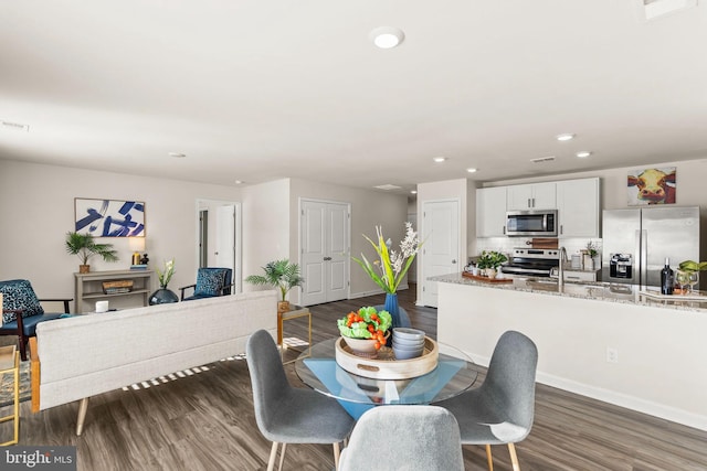 dining room with dark wood-type flooring and sink