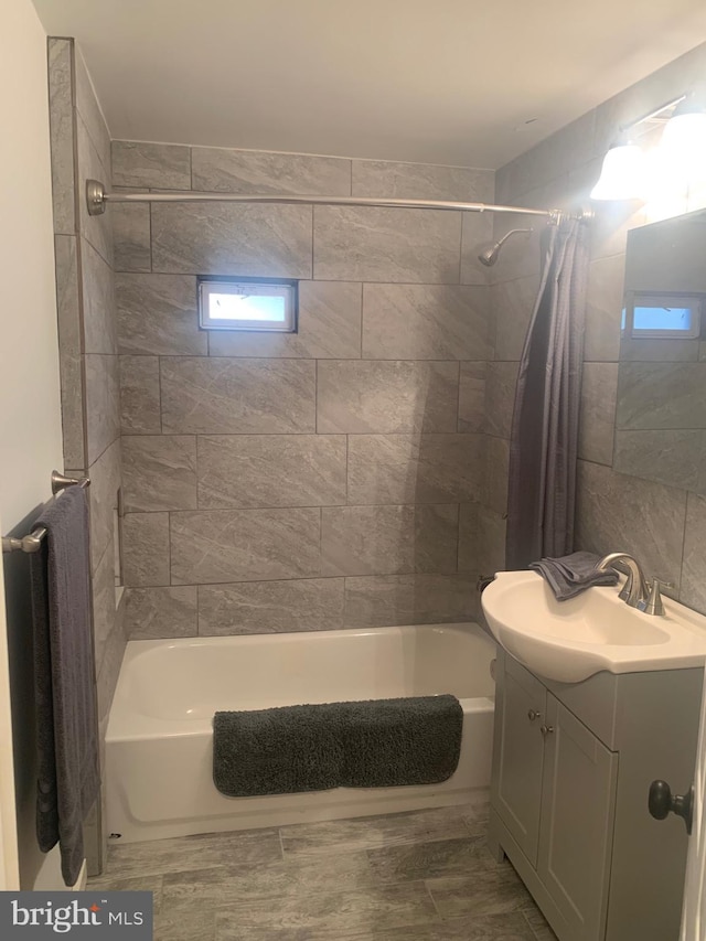 bathroom with shower / bathtub combination with curtain and vanity