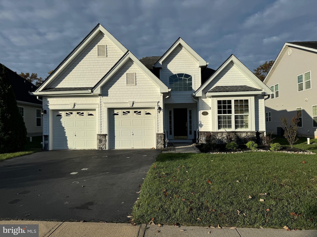 view of front of house with a garage and a front yard