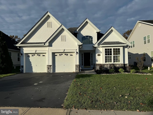 view of front of house with a garage and a front yard