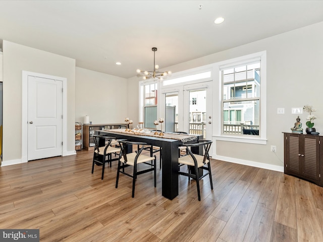 dining room featuring a notable chandelier and light hardwood / wood-style flooring