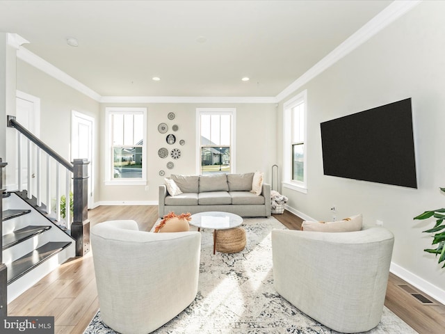 living room with light hardwood / wood-style floors and ornamental molding