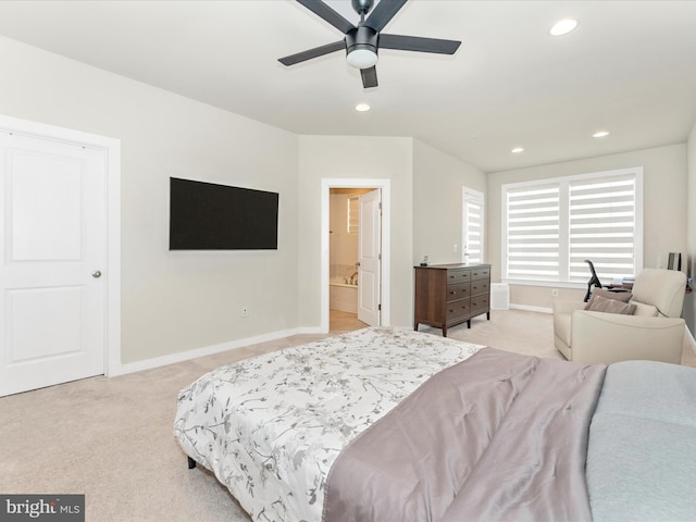 carpeted bedroom with ceiling fan and ensuite bathroom