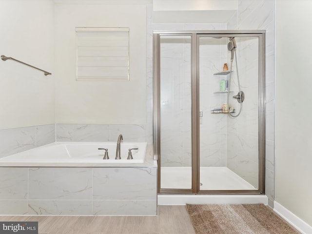 bathroom featuring hardwood / wood-style floors and plus walk in shower