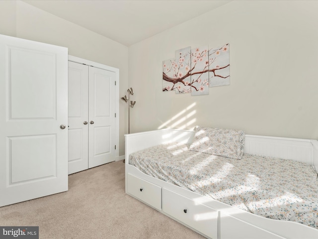 carpeted bedroom featuring a closet