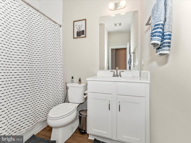 bathroom with walk in shower, toilet, vanity, and hardwood / wood-style flooring