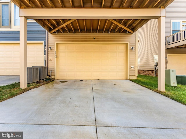 garage with central air condition unit and a carport