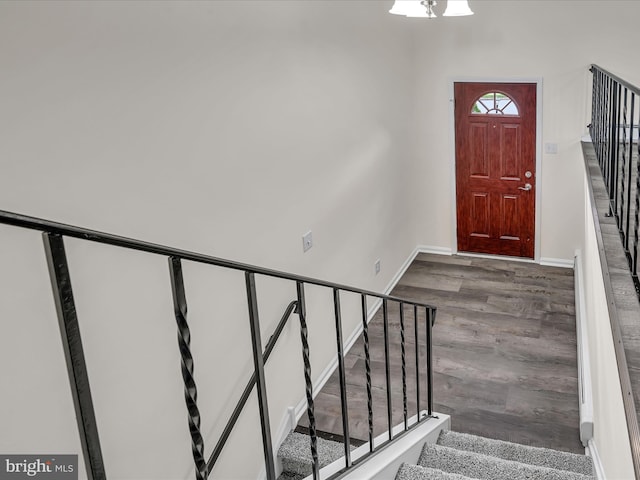 entryway featuring wood-type flooring and a notable chandelier