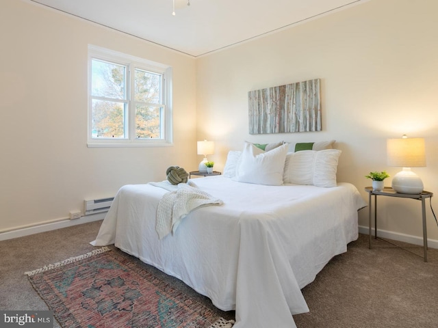 carpeted bedroom featuring a baseboard heating unit