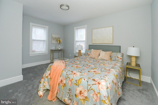 bedroom with dark colored carpet