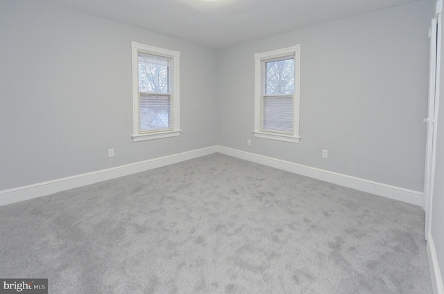 unfurnished room with light carpet