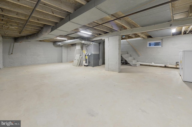 basement featuring washer / dryer and heating unit