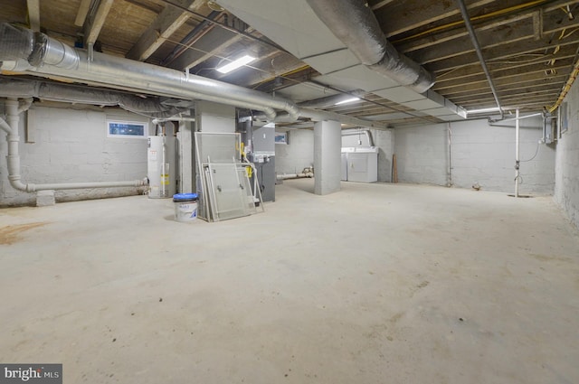 basement featuring gas water heater and heating unit